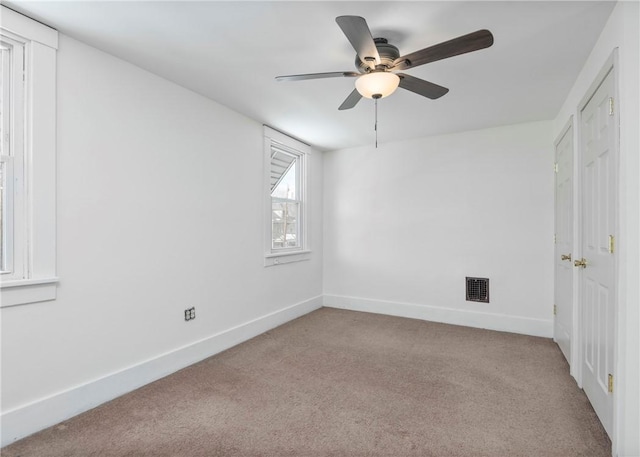 spare room with light carpet and ceiling fan