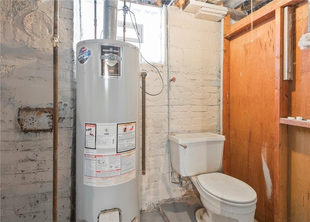 bathroom featuring toilet and water heater