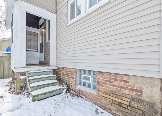 view of snow covered property entrance