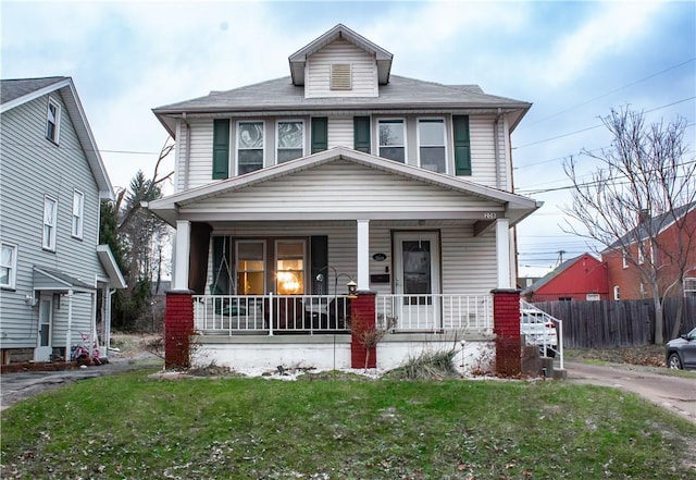 view of front of property with a front yard and covered porch