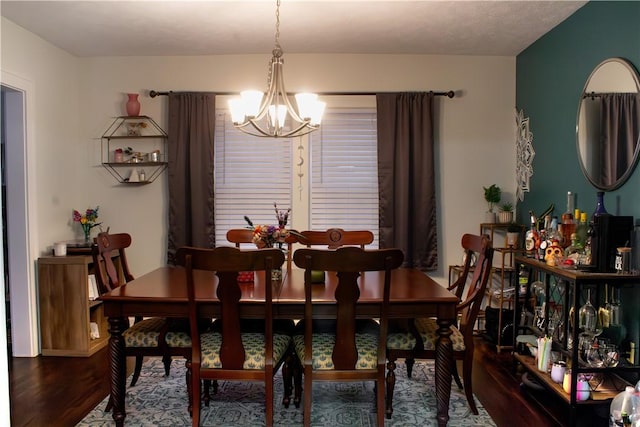 dining area with a notable chandelier and hardwood / wood-style flooring