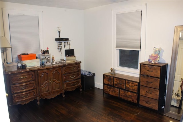 bedroom with dark hardwood / wood-style flooring