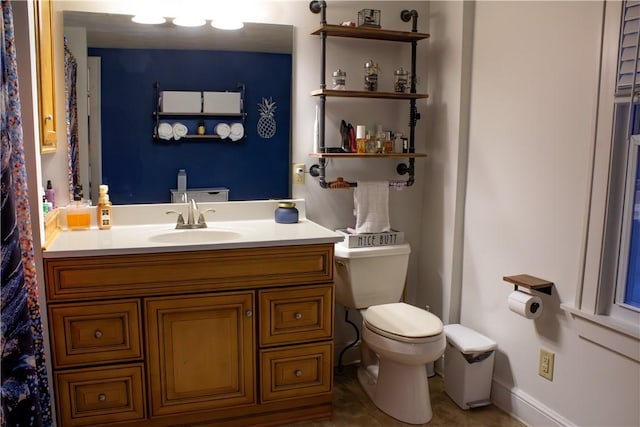 bathroom featuring toilet and vanity