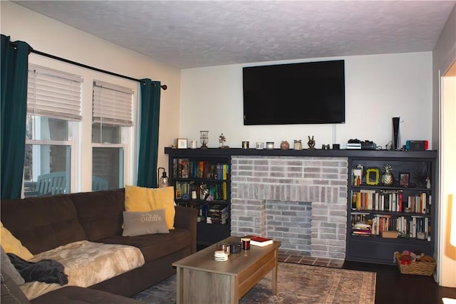 living room with a textured ceiling and a fireplace