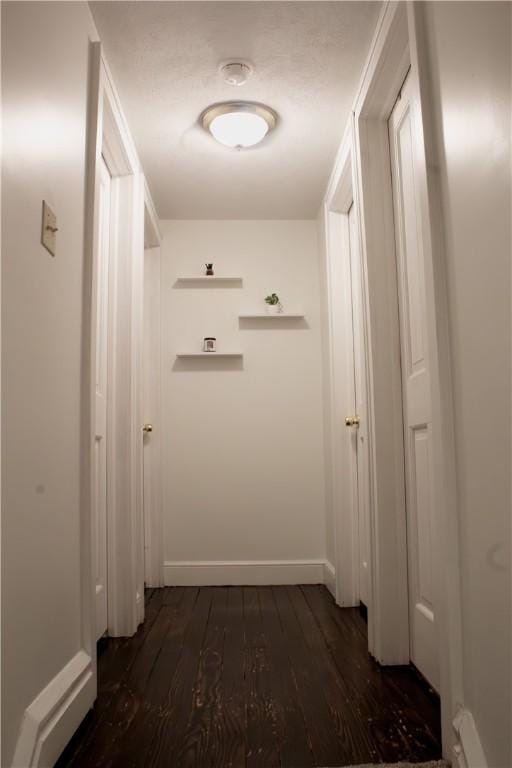 corridor with dark hardwood / wood-style floors