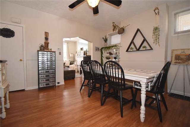 dining space with hardwood / wood-style flooring and ceiling fan