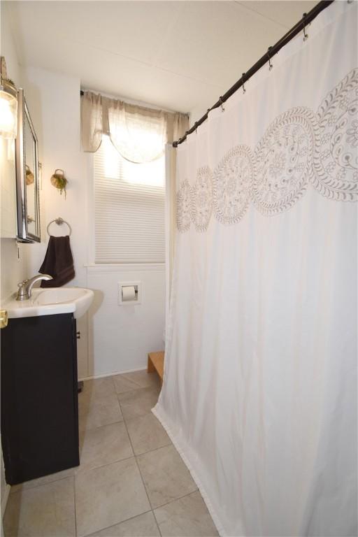 bathroom with tile patterned floors, a shower with curtain, and vanity