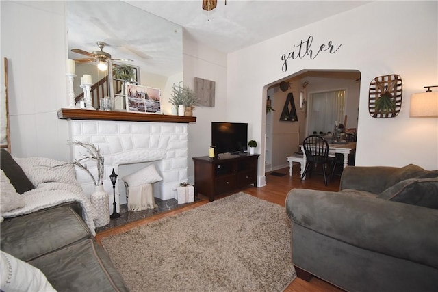 living room featuring hardwood / wood-style floors and ceiling fan