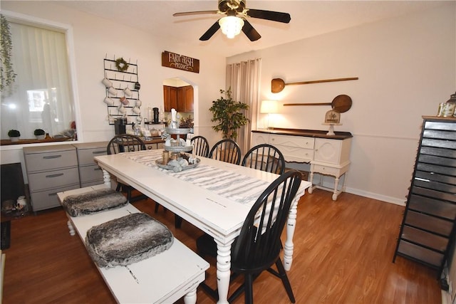 dining area with ceiling fan and wood-type flooring