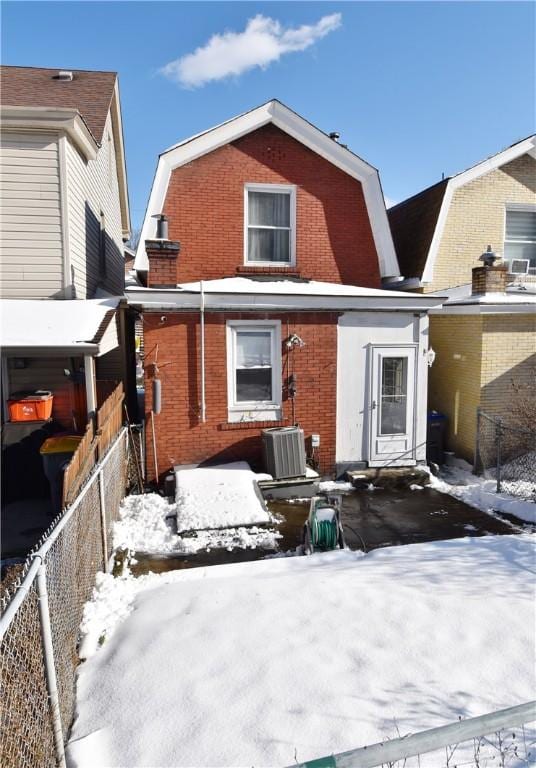 snow covered house with cooling unit