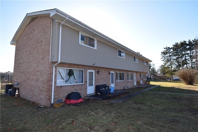 back of property featuring a lawn