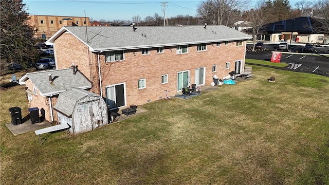 rear view of house featuring a lawn