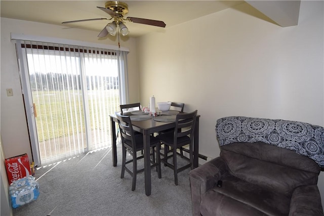 carpeted dining room featuring a wealth of natural light and ceiling fan