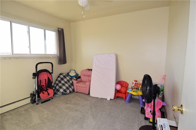 rec room featuring light carpet and a baseboard heating unit