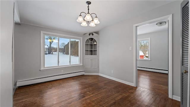 unfurnished dining area with a chandelier, baseboard heating, and dark wood-type flooring