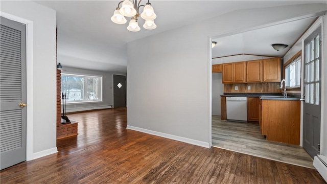 kitchen with dishwasher, sink, vaulted ceiling, a notable chandelier, and dark hardwood / wood-style flooring