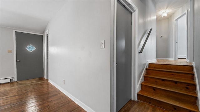 entrance foyer with vaulted ceiling, baseboard heating, and dark wood-type flooring