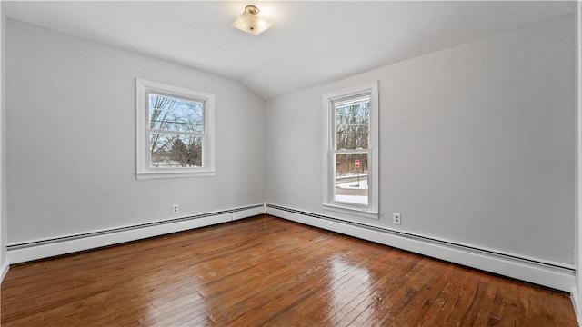 unfurnished room featuring wood-type flooring, vaulted ceiling, baseboard heating, and a healthy amount of sunlight