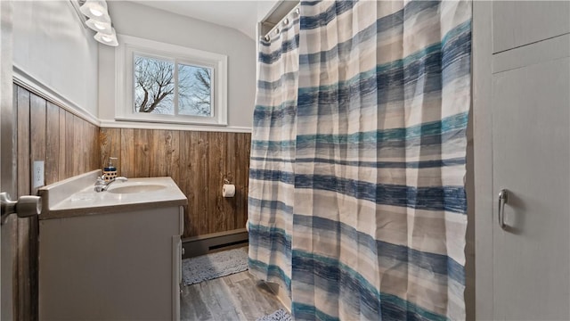 bathroom with vanity, hardwood / wood-style flooring, and wood walls