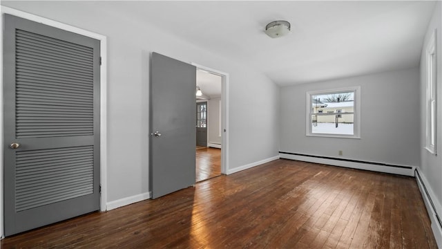 interior space featuring dark hardwood / wood-style floors and a baseboard heating unit