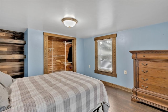 bedroom with a closet and dark wood-type flooring