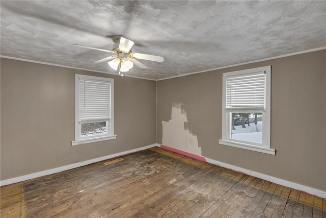 spare room featuring ceiling fan, dark hardwood / wood-style flooring, and ornamental molding