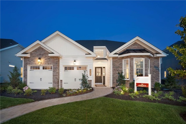 view of front of property with a garage and a front lawn