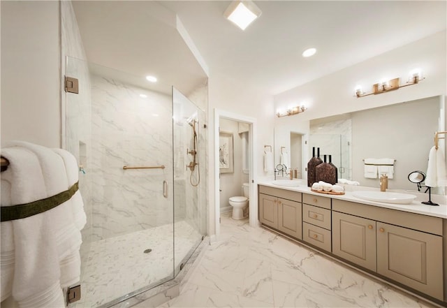 bathroom featuring vanity, toilet, and a shower with door