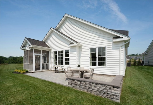 back of house featuring a sunroom, a yard, and a patio