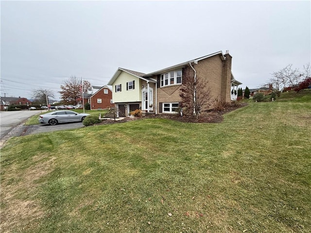 view of front facade with a garage and a front lawn