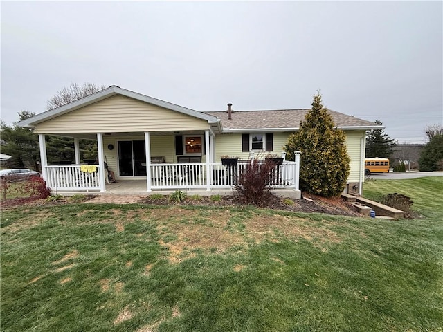 back of house with a porch and a yard