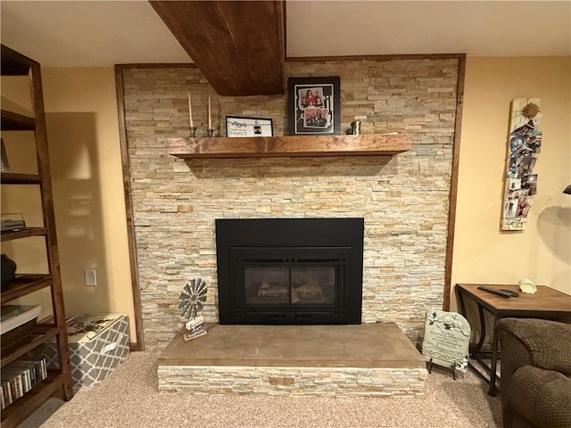 interior details featuring carpet and a large fireplace