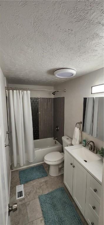 full bathroom featuring tile patterned floors, shower / tub combo with curtain, vanity, and toilet