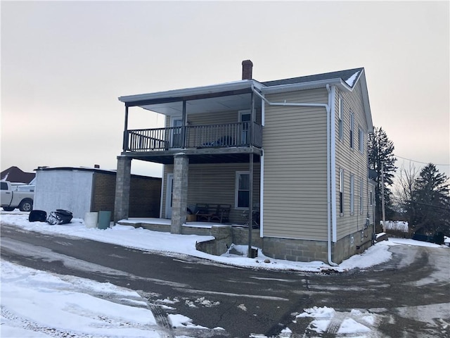 exterior space featuring a balcony and a porch