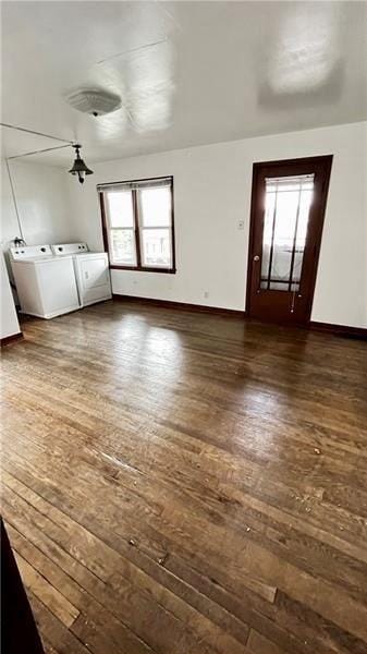 interior space featuring separate washer and dryer, dark hardwood / wood-style floors, and a healthy amount of sunlight