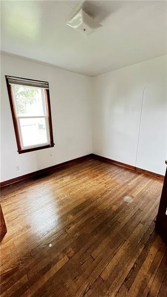 empty room featuring dark hardwood / wood-style flooring