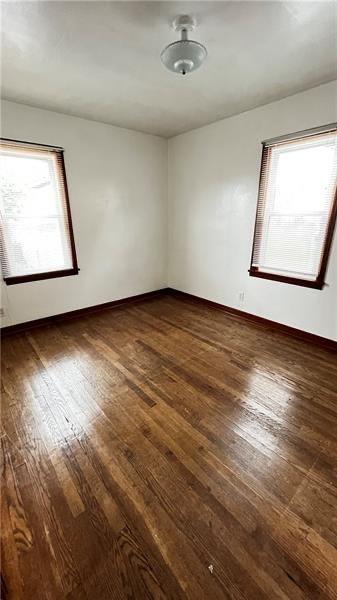 unfurnished room featuring dark wood-type flooring