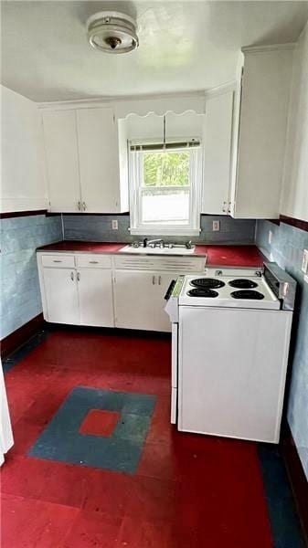 kitchen featuring sink, white cabinets, and white electric range oven