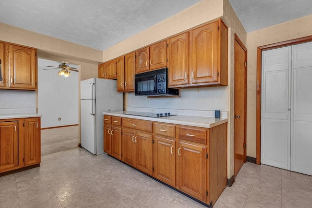 kitchen with black appliances, ceiling fan, and light colored carpet