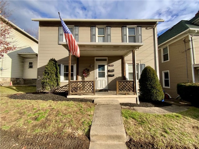 view of front facade with a porch and a front lawn