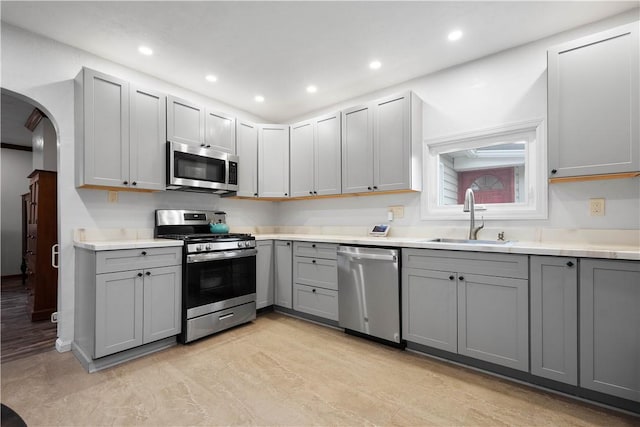 kitchen featuring gray cabinetry, sink, and stainless steel appliances