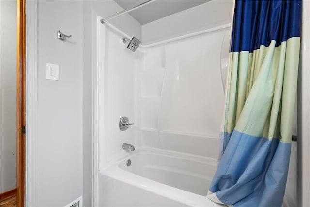 bathroom with shower / bathtub combination with curtain