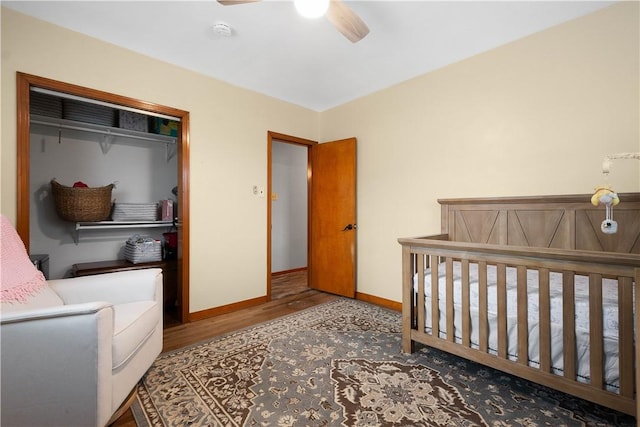 bedroom with wood-type flooring, a closet, and ceiling fan