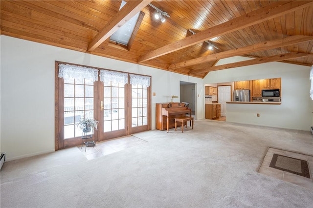 unfurnished living room with light carpet, a skylight, high vaulted ceiling, and wood ceiling