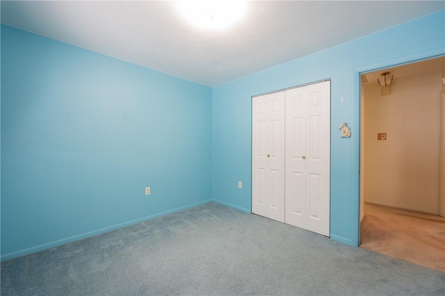 unfurnished bedroom featuring a closet and carpet