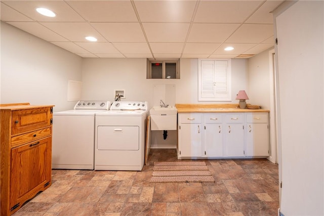 laundry room with cabinets, sink, and washing machine and clothes dryer