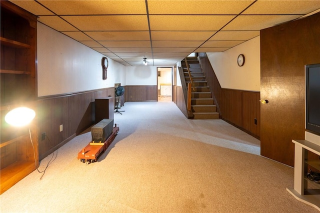 basement with light carpet and a drop ceiling