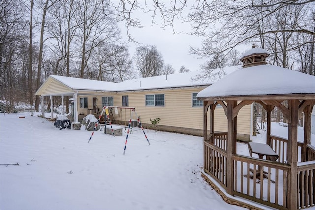 view of snow covered rear of property