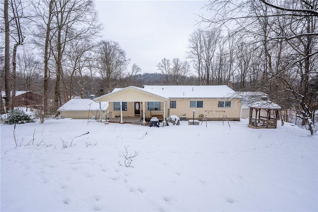 view of snow covered rear of property