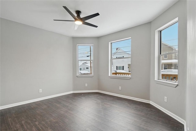 spare room with ceiling fan and dark hardwood / wood-style flooring